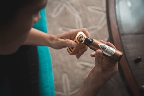 Man filling up his vaper with vape juice.