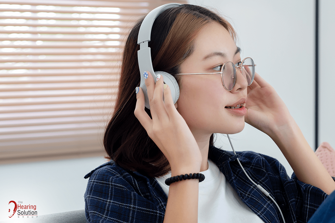 Youth listening through headphones